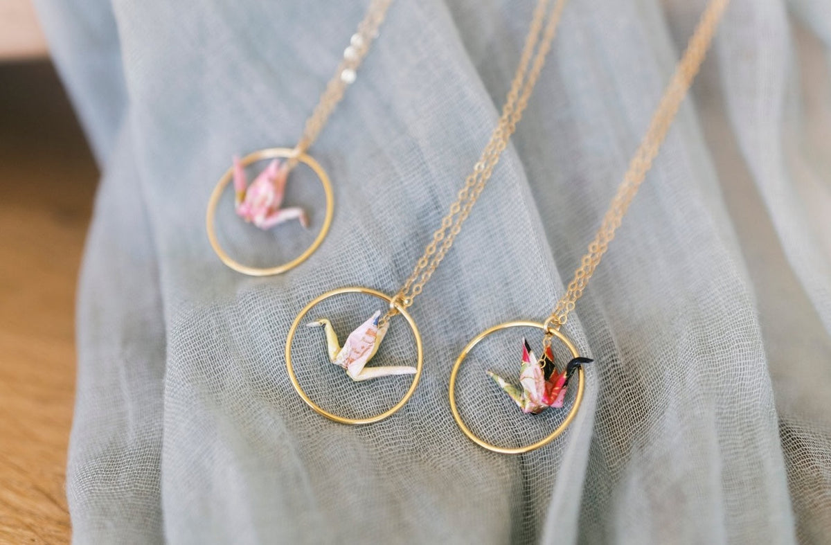 Necklace with circular pendants on a light blue fabric background