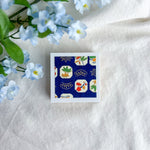 Blue design washi paper on a white fabric background with blue flowers.
