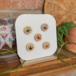 Set of wooden buttons on a display stand with a natural background