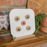 Set of wooden buttons on a display stand with a natural background