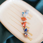 Decorative threaders on a plate with a teal fabric background