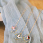 Necklace with circular pendants on a light blue fabric background