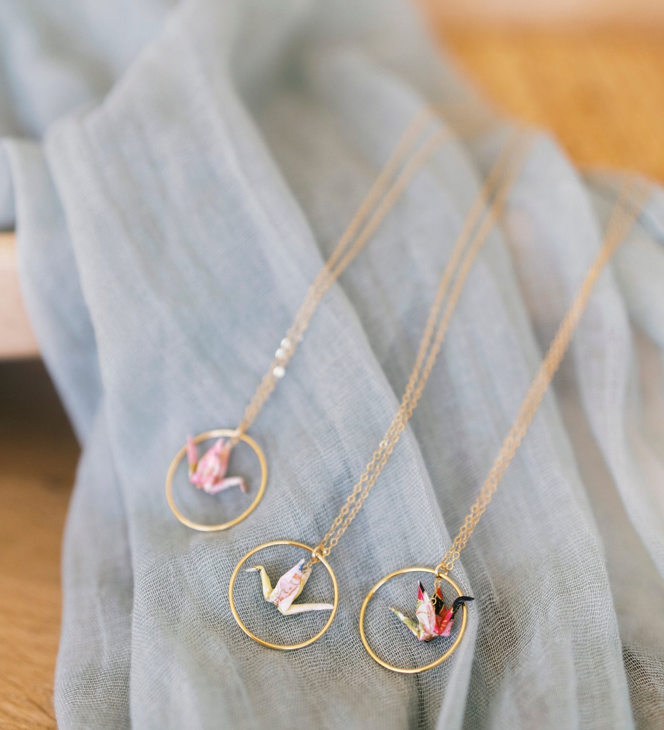 Necklace with circular pendants on a light blue fabric background