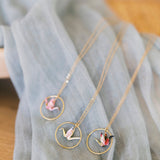 Necklace with circular pendants on a light blue fabric background
