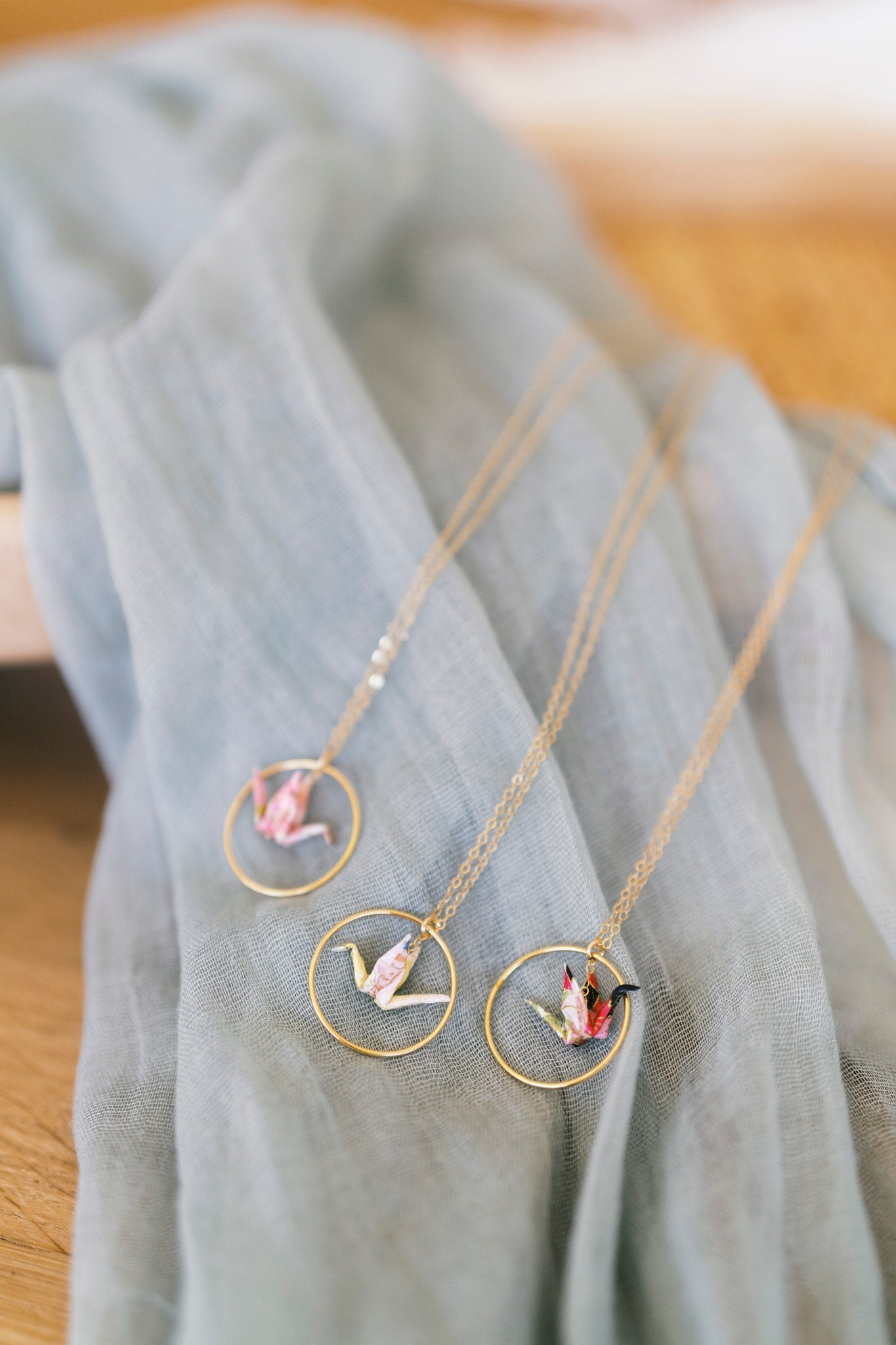 Necklace with circular pendants on a light blue fabric background