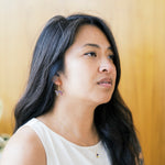 Woman with long dark hair wearing origami butterfluy thraeder earrings