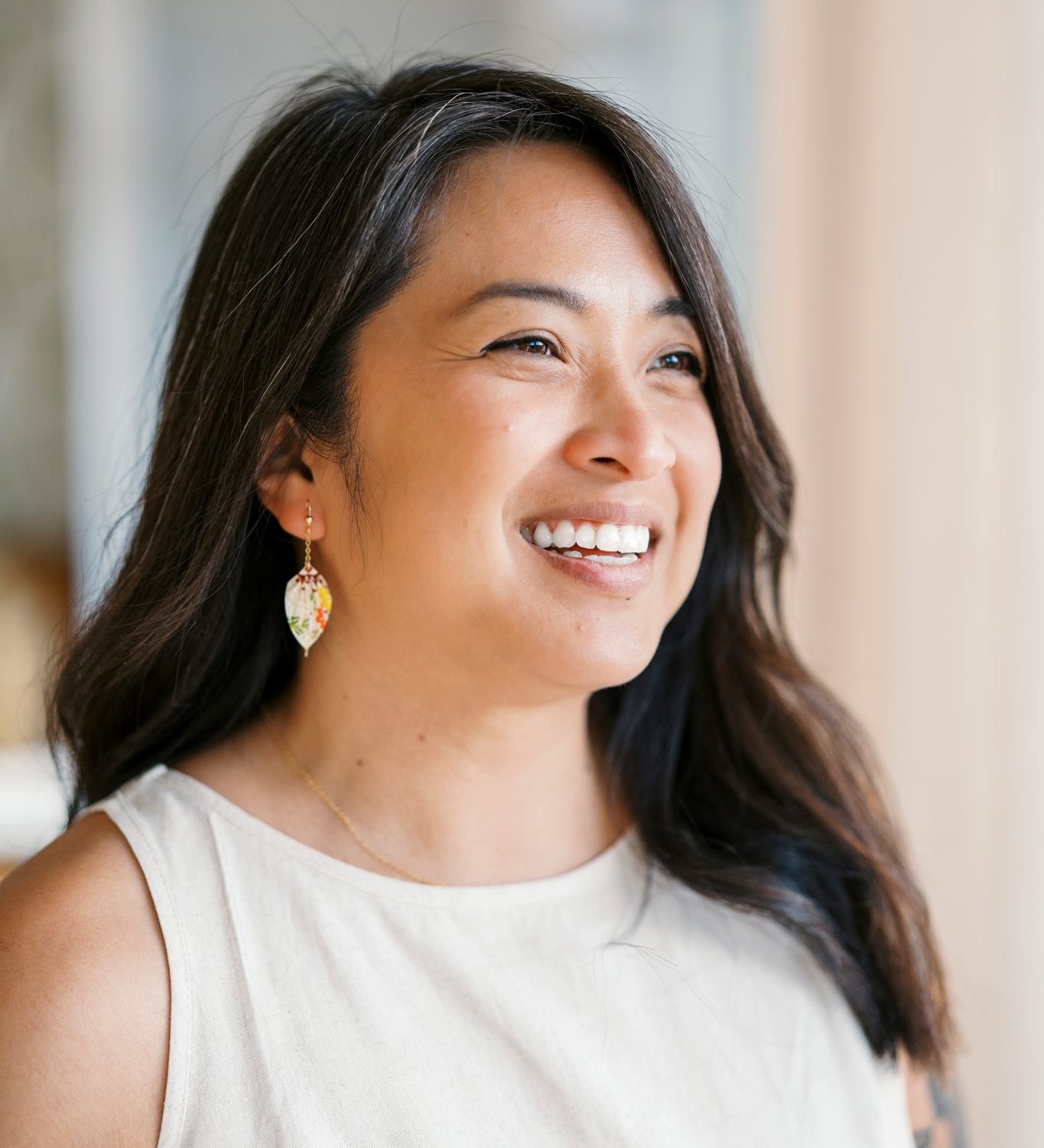 Model wearing origami leaf earrings