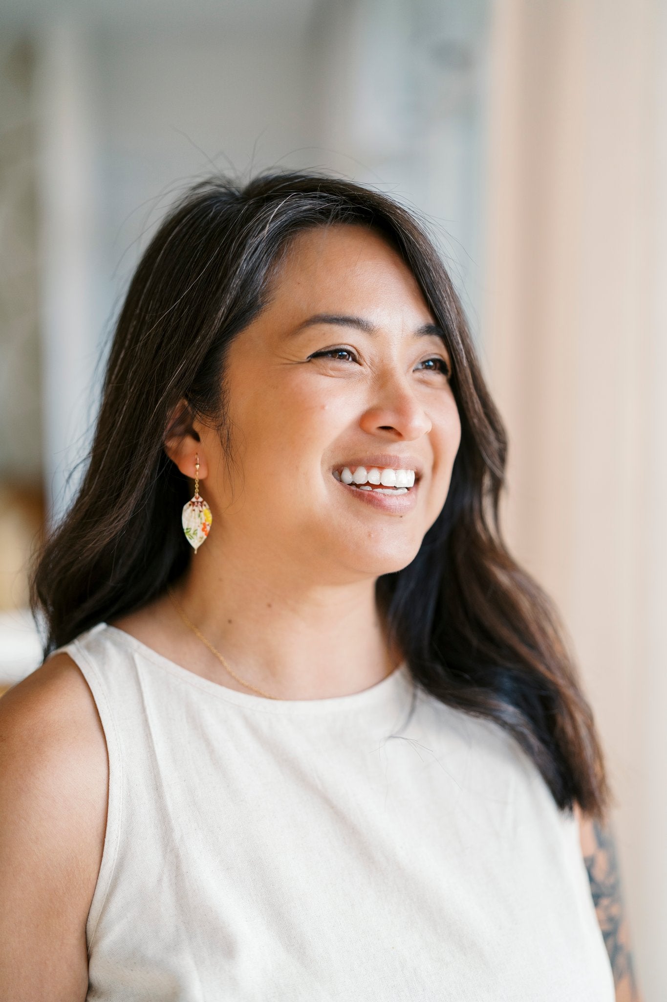 Model wearing origami leaf earrings