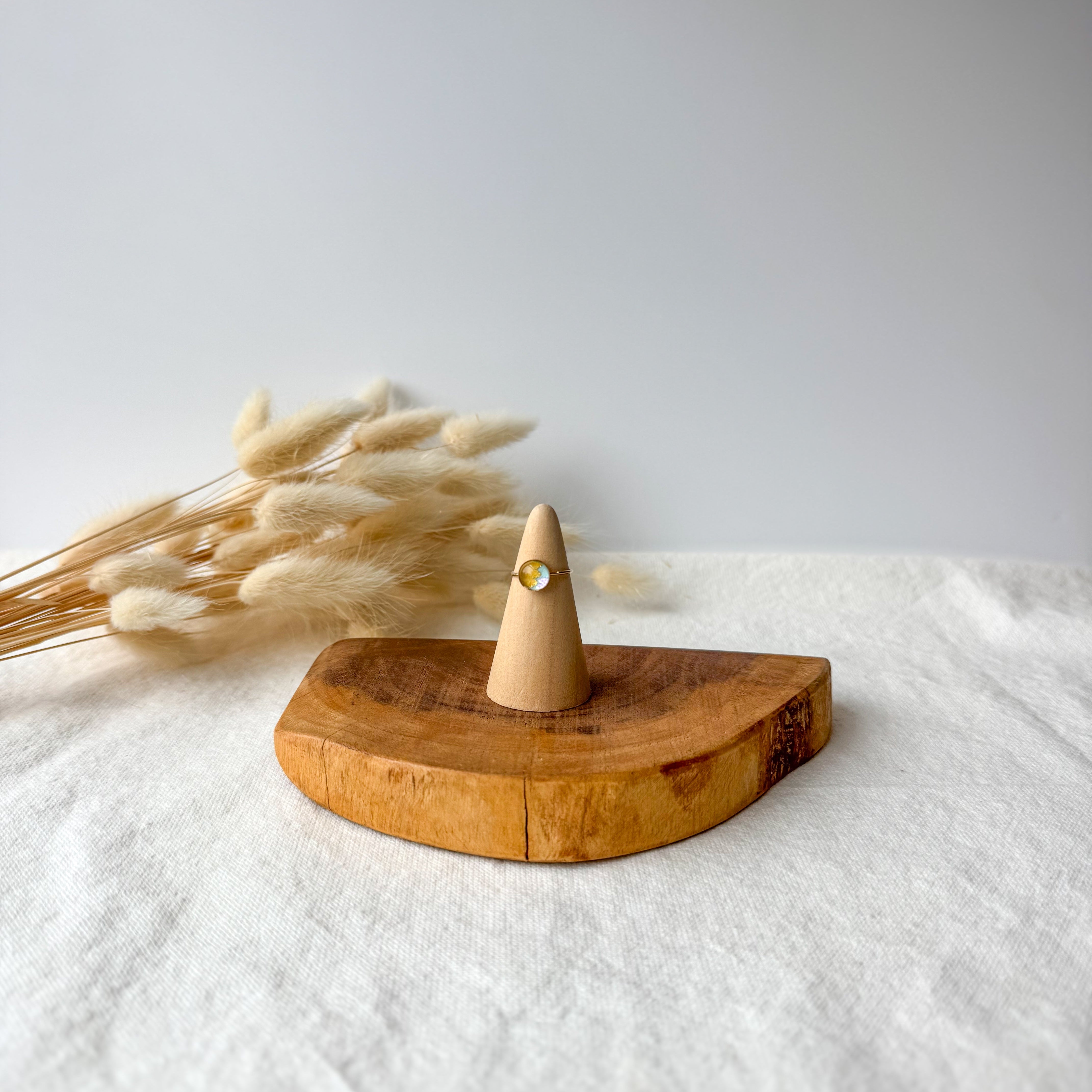 Wooden ring holder with a dainty ring
