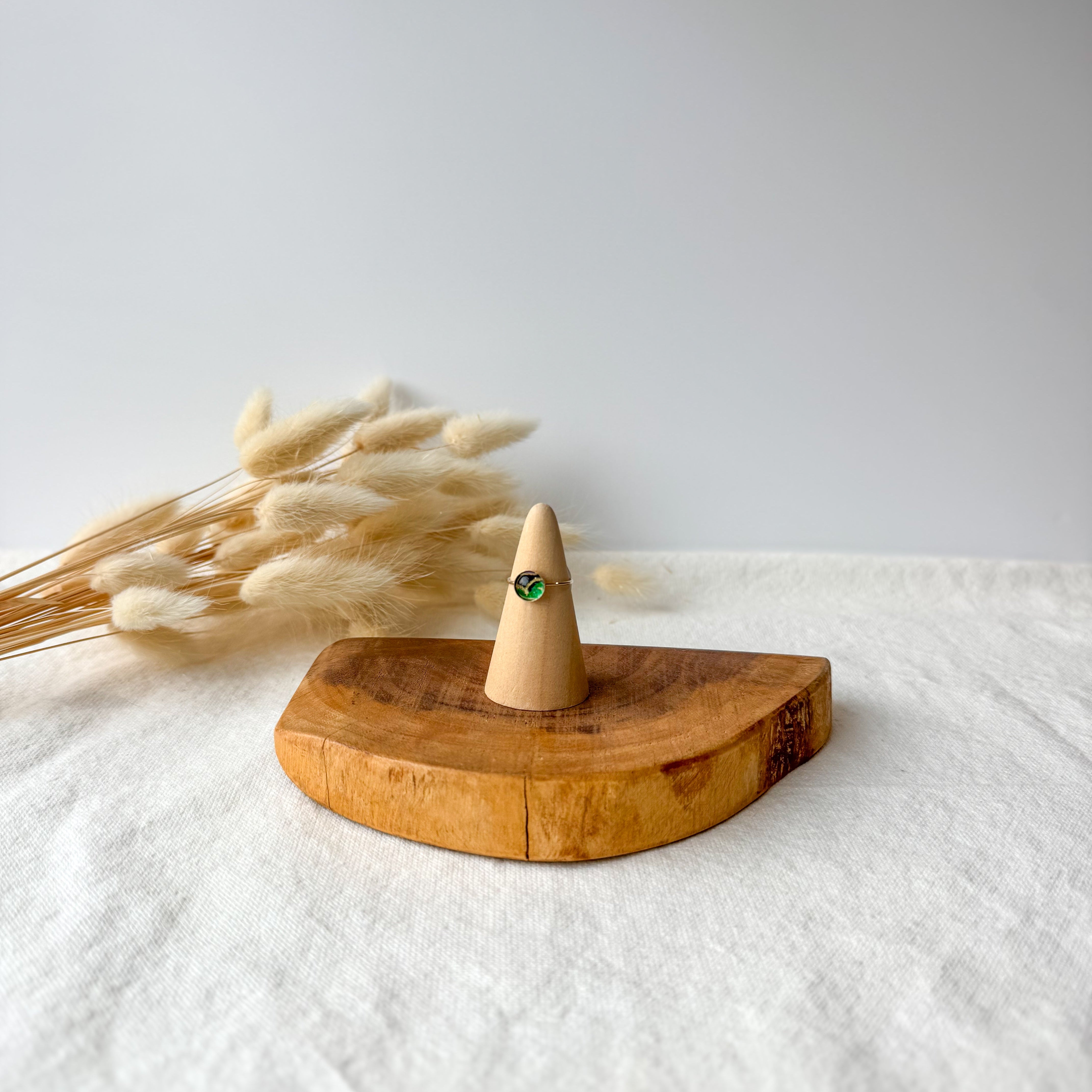 Wooden ring holder with a dainty ring