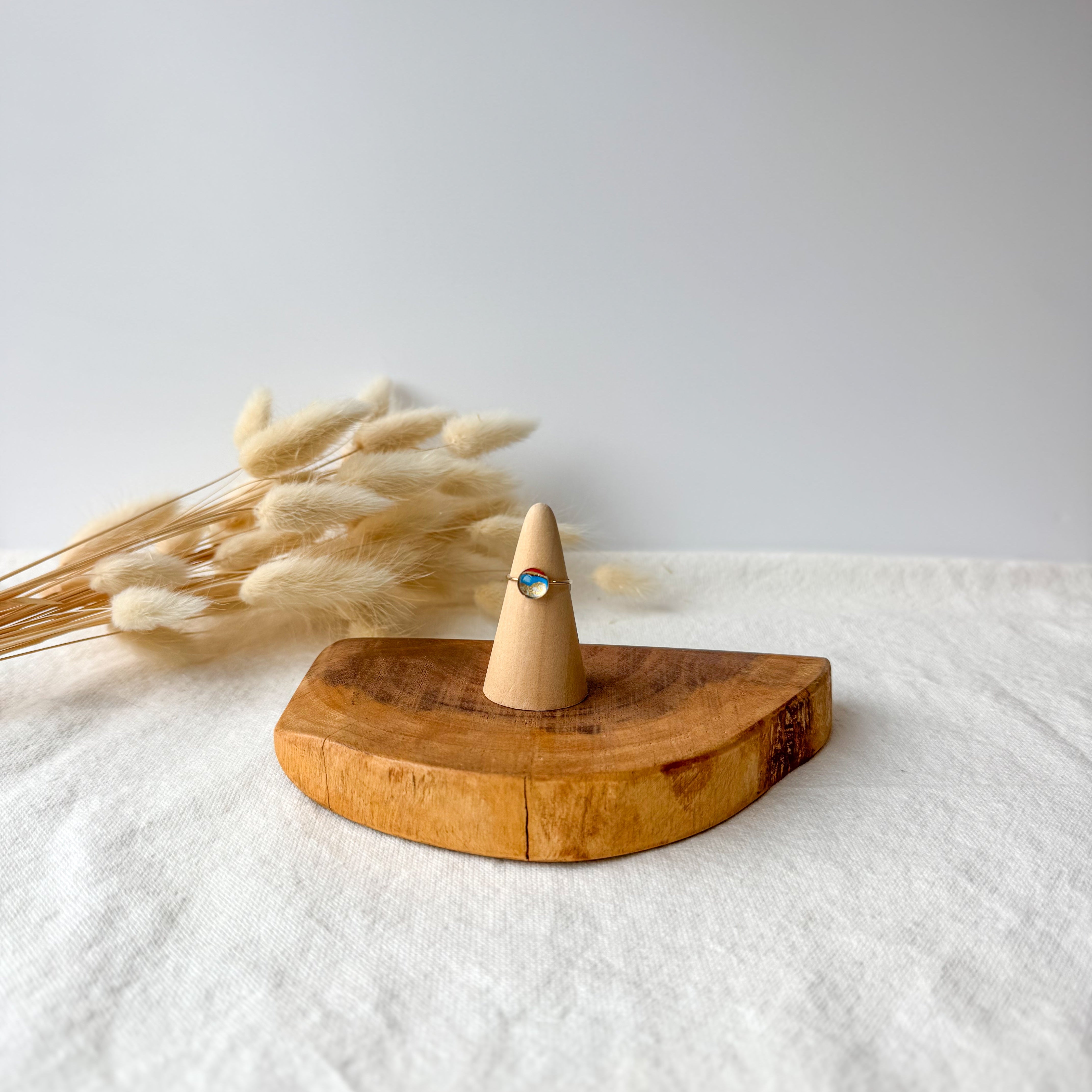 Wooden ring holder with a dainty ring