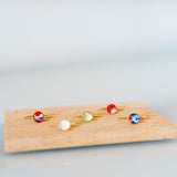 Set of colorful rings on a wooden board against a light gray background